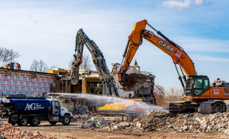 Water Truck Spraying Rubble While Excavators Demolish Campbell's Soup Plant
