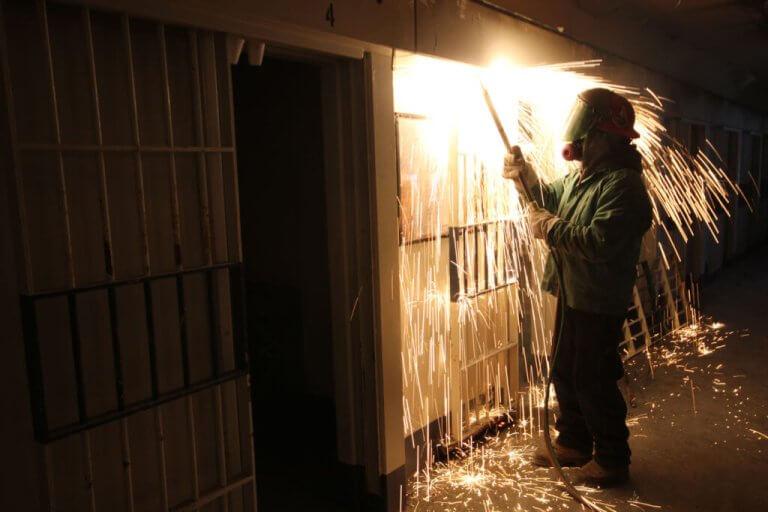 Priestly Demolition Welder Cutting Jail Cell Door